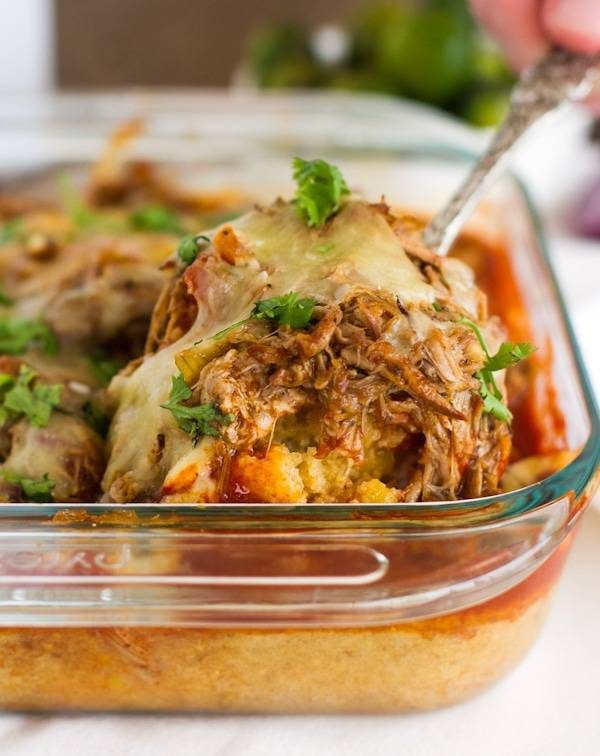 with carnitas in a clear baking dish.