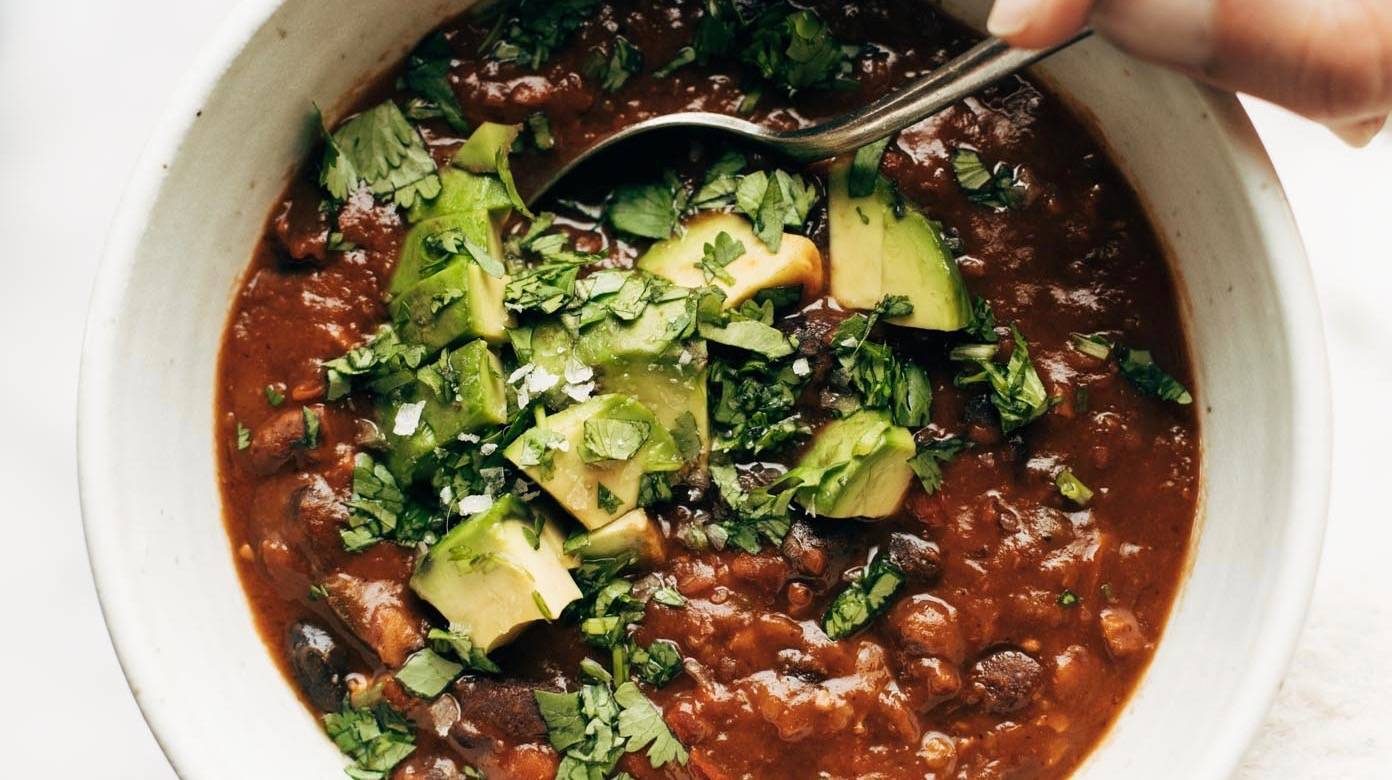 Instant Pot Pumpkin Walnut Chili in bowl with spoon.
