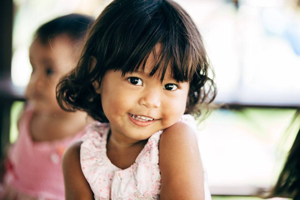 Little girl smiling at camera.