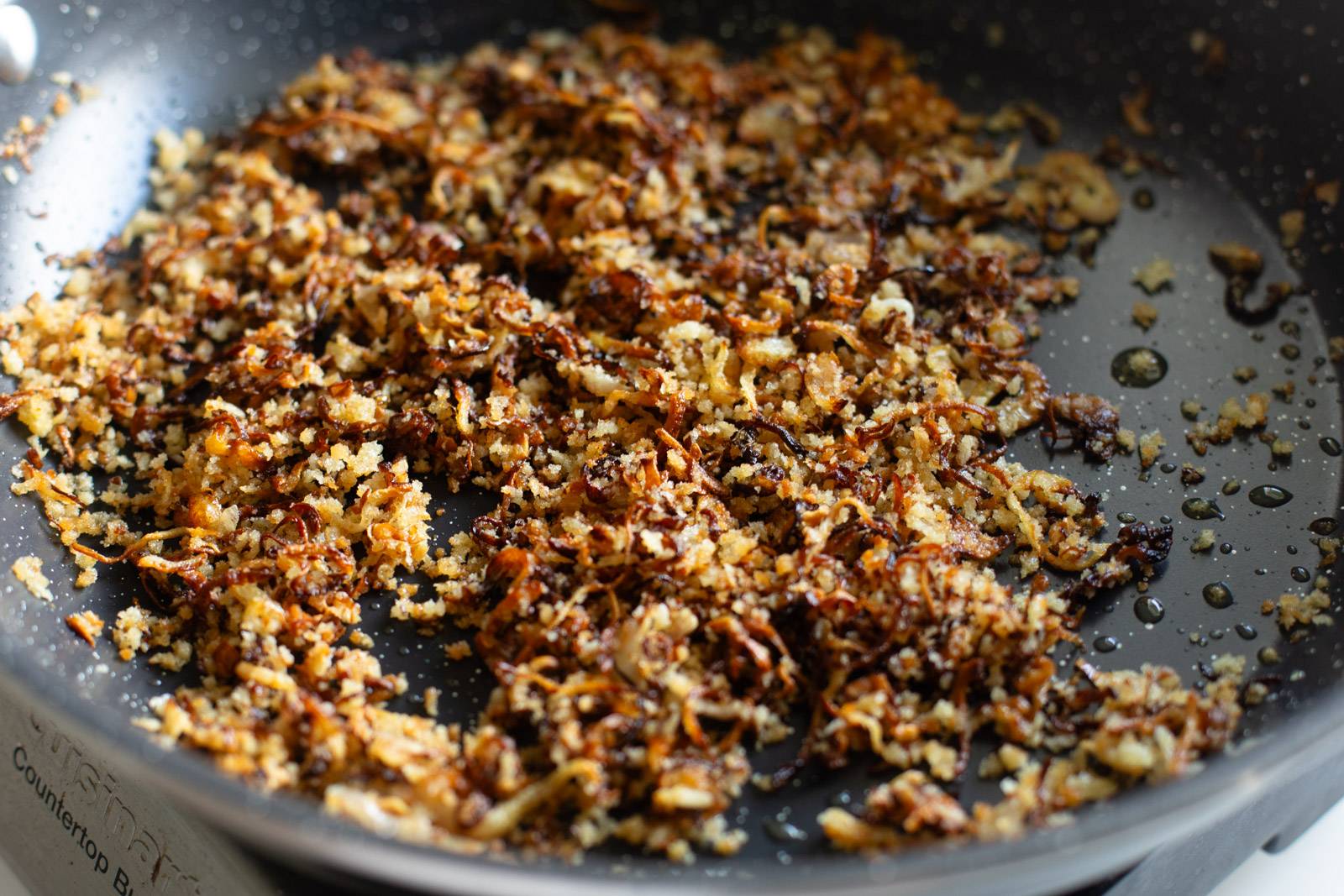 Shallot crispies in a pan.