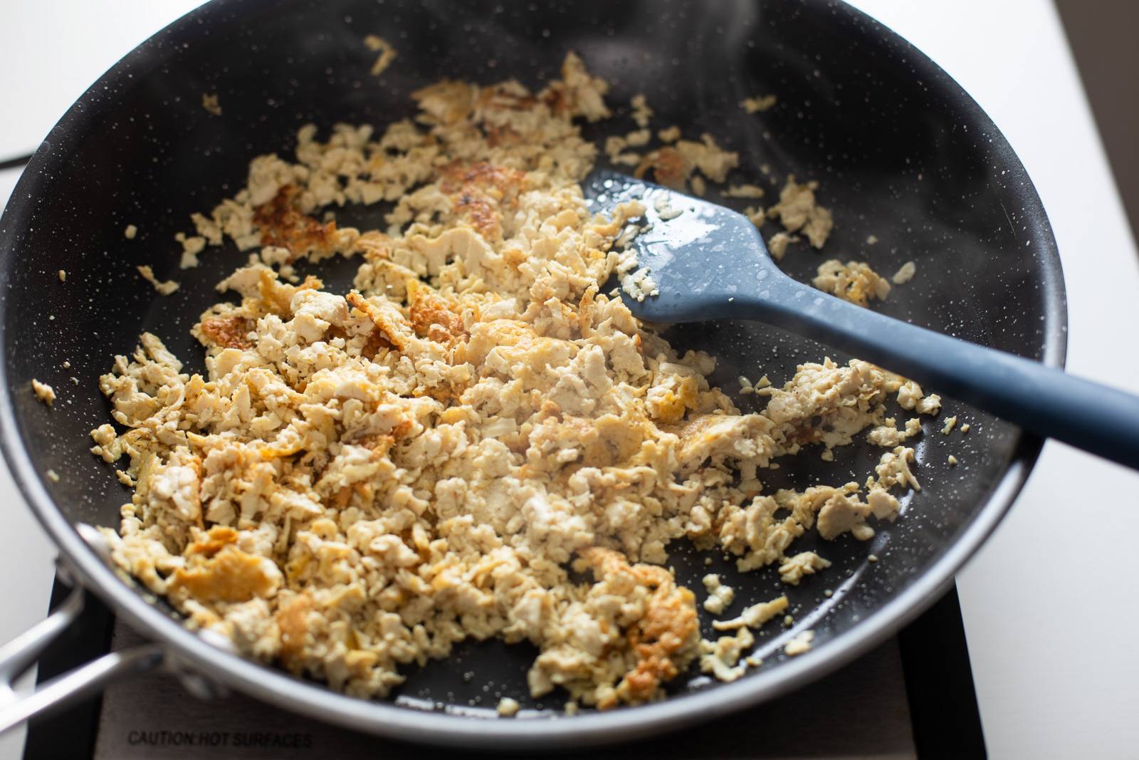 Crisping tofu in a skillet.