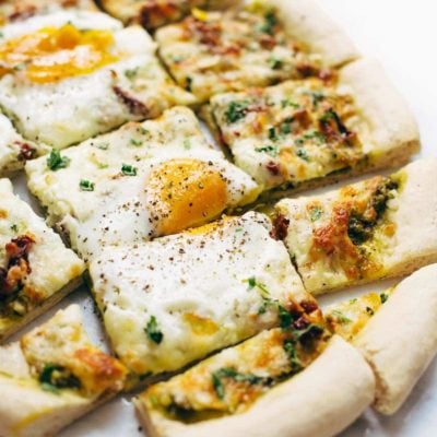 Breakfast Pizza sliced with eggs.
