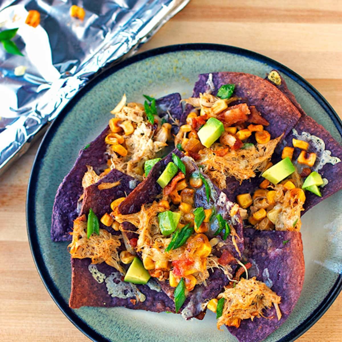 Crab avocado nachos on a blue plate.