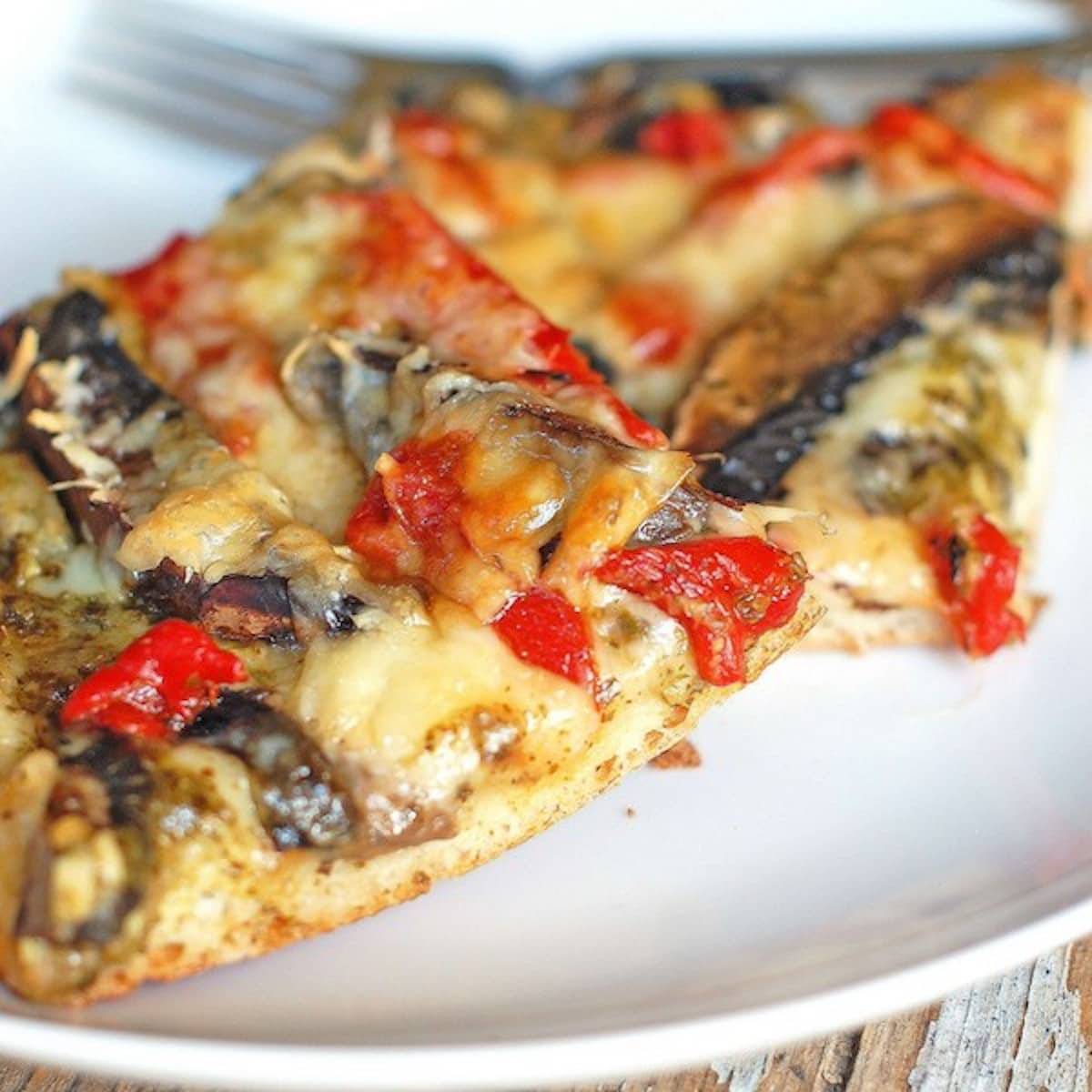 Pesto pizza with portobello mushrooms and red peppers. 